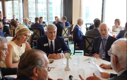 Executives in conversation at a luncheon